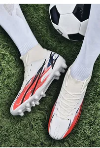 Detailed view of high-top soccer cleats with flyknit collar on turf.