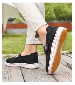 Close-up of women's black breathable fly-knit walking shoe shown on model outdoors
