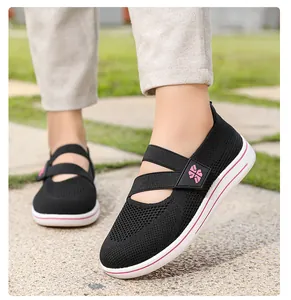 Detailed side view of black breathable mesh slip-on walking shoes for women