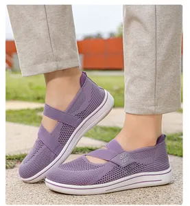 Detail view of purple women's breathable knit mesh walking shoes with crisscross straps