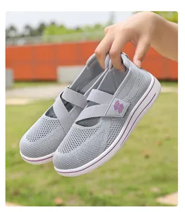 Detail showing grey breathable mesh slip-on women's walking shoes with purple logo