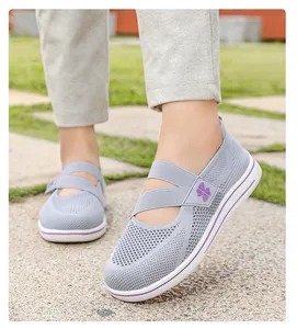 Close-up of grey breathable mesh walking shoes on model in outdoor setting