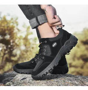 Close-up side view of black men's outdoor hiking shoes with rugged anti-slip rubber soles