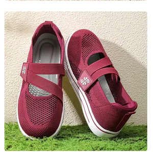 Close-up of burgundy breathable knit mesh women's walking shoes with cross straps.