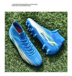Professional blue high-top soccer cleats with spikes shown on green artificial grass