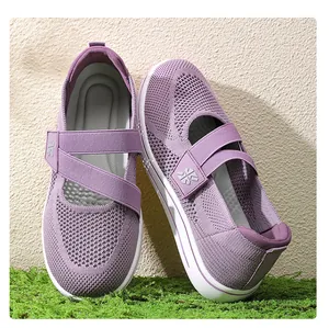 Detailed side view of purple breathable mesh walking shoes featuring cross straps