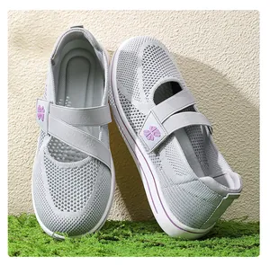 Detail view of grey breathable mesh walking shoes with purple floral strap logo decor