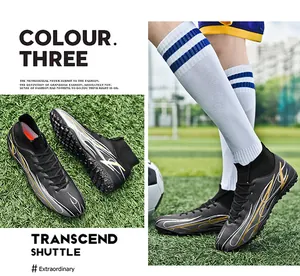 Side view of black high-top soccer shoes with flame patterns on artificial turf.