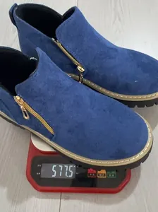 Detailed view of blue suede side-zip ankle boots weighing 577.5g on a digital scale