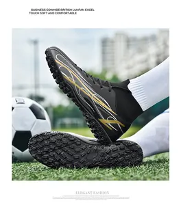 Close-up of high-top soccer shoes with knitted collar and textured leather upper