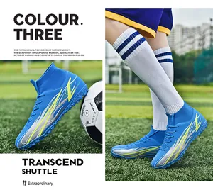 Detailed view of blue high-top soccer shoes with knitted sock collar on field