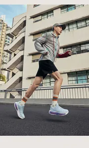 Side view of light blue air cushion running shoes worn by a male runner outdoors