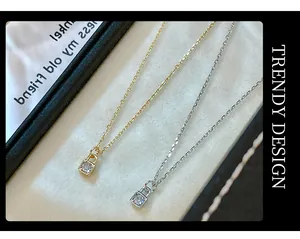 Close-up of S925 silver lock pendant necklaces with single diamond in gold and silver finish