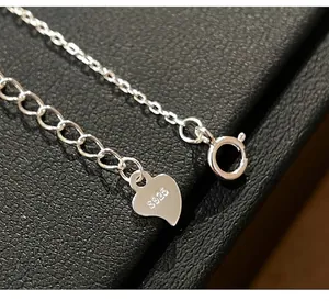 Detailed macro view of S925 sterling silver necklace heart tag and security stamp