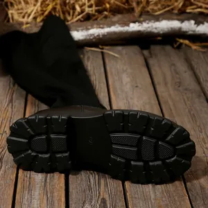Elegant black knitted over-the-knee boots featuring thick lugged non-slip rubber soles