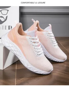 Close-up of pink women's breathable fly-knit sneakers with white thick soles