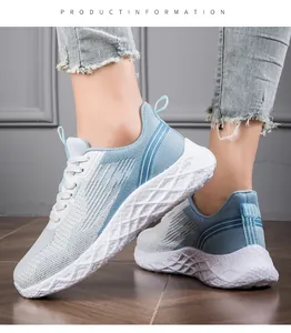 Close-up of lightweight light blue flyknit running shoes for women with mesh texture