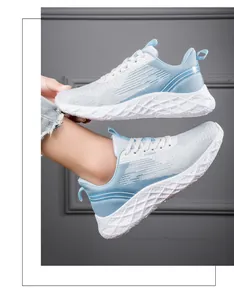 Side view of women's breathable light blue mesh running shoes with textured sole.