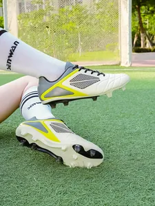 Detail shot of professional soccer cleats with FG studs on artificial grass field