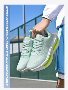 Close-up of mint green breathable air cushion running shoes held outdoors