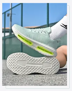 Close-up of mint green breathable mesh running shoes with visible air cushion sole