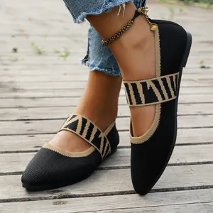 Close-up of black breathable knit pointed toe flats with a zebra print strap detail