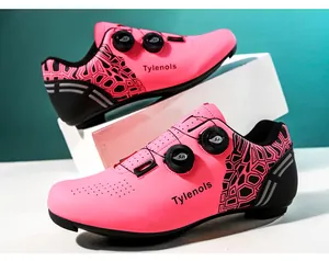 Close-up of vibrant pink cycling shoes featuring dual rotary buckles and Tylenols logo