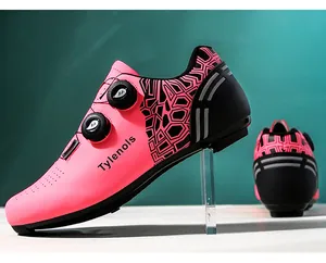 Detail view of pink and black cycling shoe with dual rotary buckle closure system.
