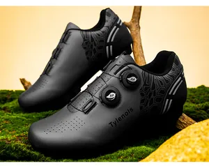 Professional detail of black cycling shoes with dual rotating buckles on a natural moss background