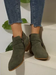 Olive green pointed-toe Chelsea ankle boots with cross straps and side zipper detail