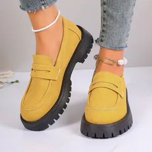 Comfortable yellow suede loafers with thick black platform lug soles in British retro style