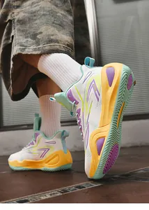 Detail view of high-top basketball shoes with vibrant purple and yellow accents on sole