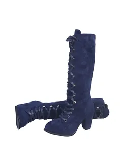 Detail view of navy blue suede lace-up boots with chunky high heel design