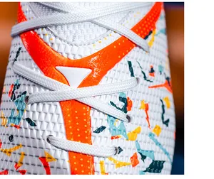 Close-up of professional football boot upper with mesh texture and colorful patterns