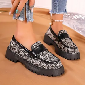 Detail view of patterned platform loafers with chunky lug soles in vintage style