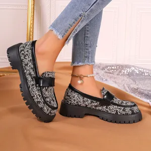 Side view detail of patterned loafers with thick platform lug sole and vintage design