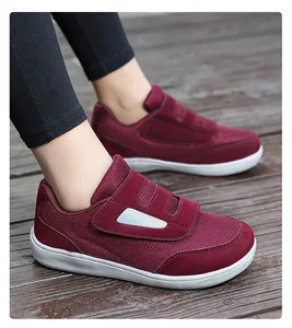 Detailed side view of burgundy fly-knit walking shoes with Velcro straps.