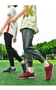 Lightweight breathable mesh walking shoes shown in a professional outdoor sports field.