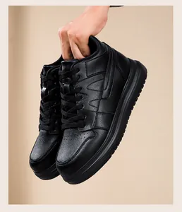 Close-up of black leather platform sneaker texture and sole details held by hand