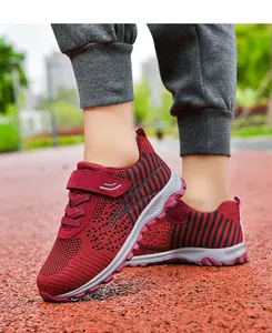 Close-up of maroon flyknit walking shoes with breathable mesh and comfortable sole