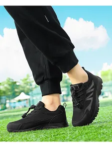 Close-up of black breathable mesh walking shoes for seniors on green grass background