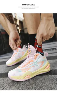 Detailed action shot of pink and yellow unisex low-top basketball shoes during lacing