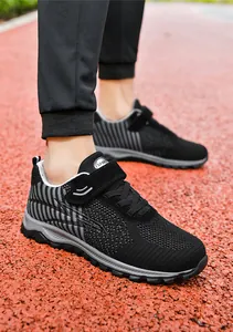 Detailed close-up of breathable black flying knit walking shoes with grey stripes