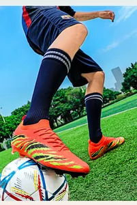 Chaussures de football professionnelles en maille fly-knit orange et vert vif