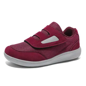 Maroon fly-knit walking shoe with velcro strap and wide toe box on white background