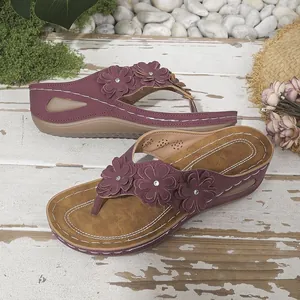 Vista detallada de las sandalias de cuña burdeos con tres adornos de flores madera