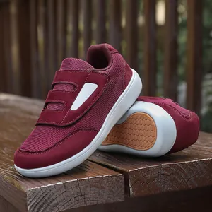 Burgundy mesh walking shoes with dual velcro straps and a white sole for seniors