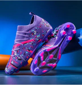 Detailed view of purple fly-knit soccer cleats with colorful patterned upper and studded sole.