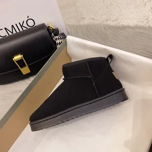 Close-up of stylish black classic mini snow boots featuring warm lining and durable thick sole