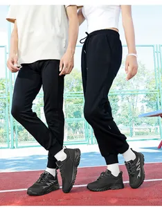 Close-up of lightweight black mesh athletic shoes for men and women on a running track